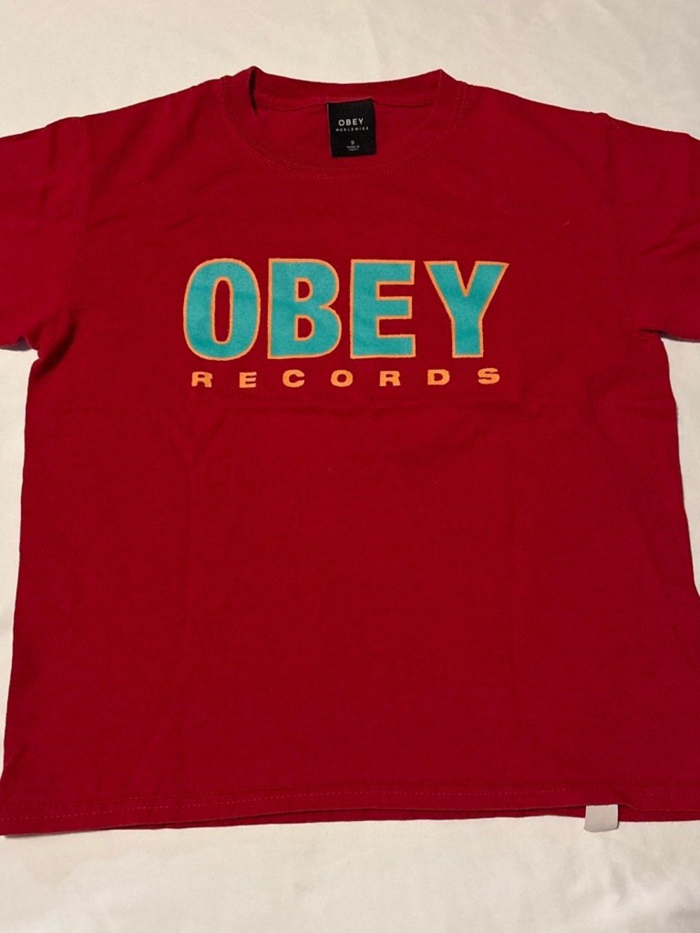 Obey Men's Red Tee with Teal Logo and Yellow Accents